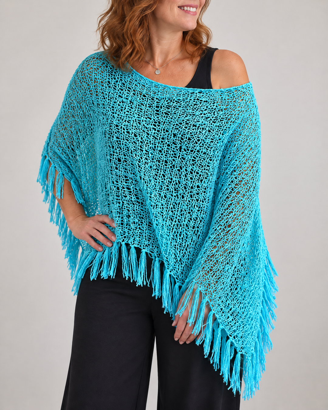 Oceane - Open Knit Tassel Poncho in turquoise, side view