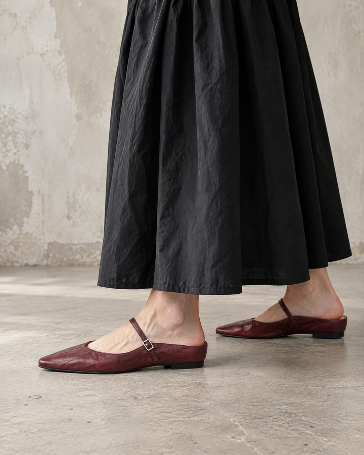 Felicie - Leather Mary Jane Mules in burgundy, side view, with a black maxi dress