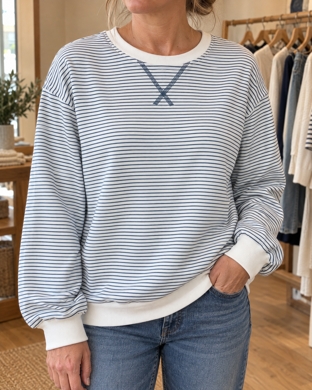 Charlotte - Fine Stripe Pullover in blue, detail of the ribbed neckband, the stitched X and the fine stripes