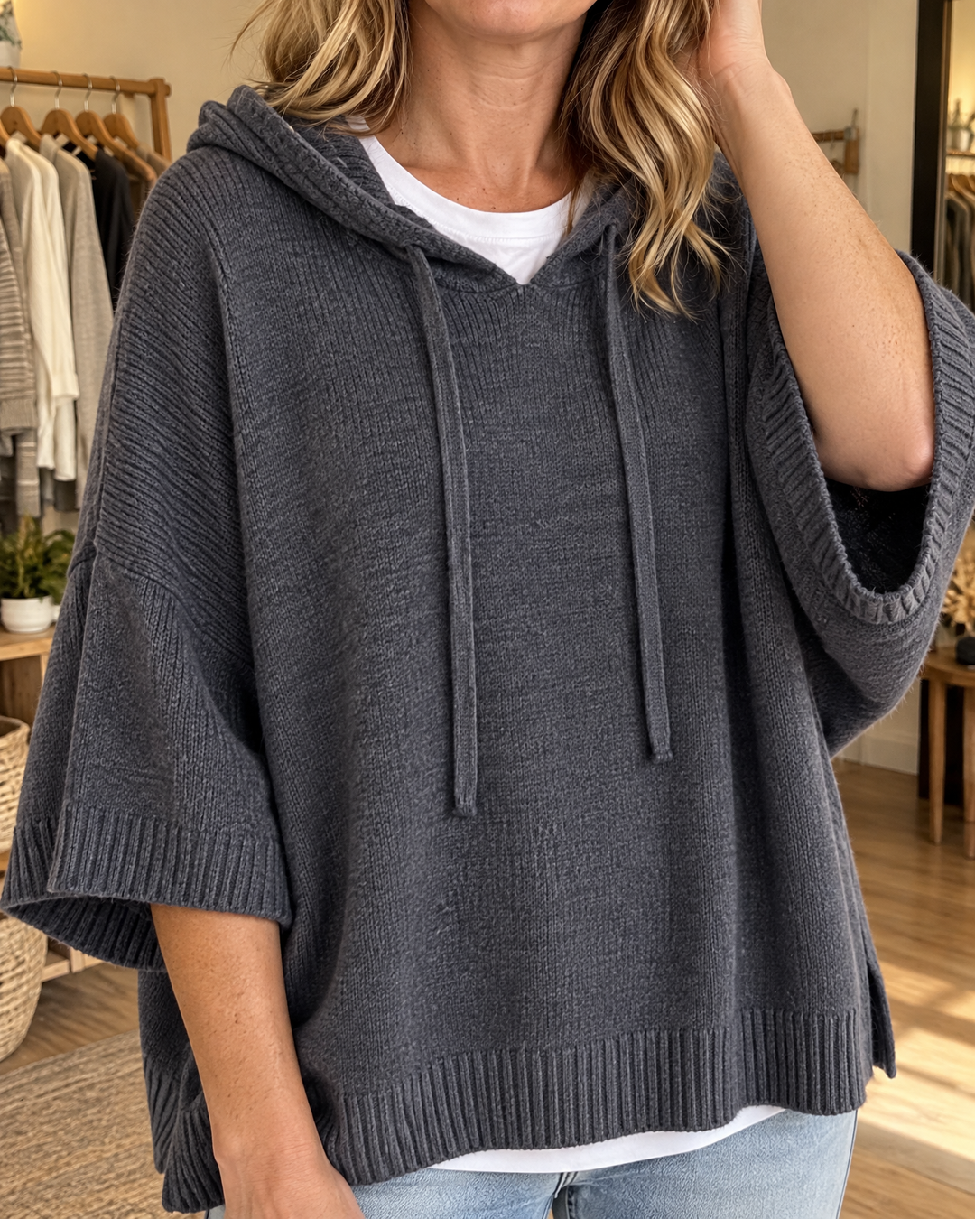 Mariette - Hooded Knit Poncho in grey, detail of the hood, the cord and the ribbed cuff