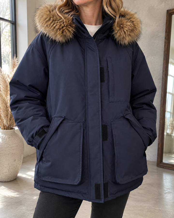 Francine - Oversized Hooded Parka in navy, detail of the fur-trimmed hood, the storm placket and the flap pockets