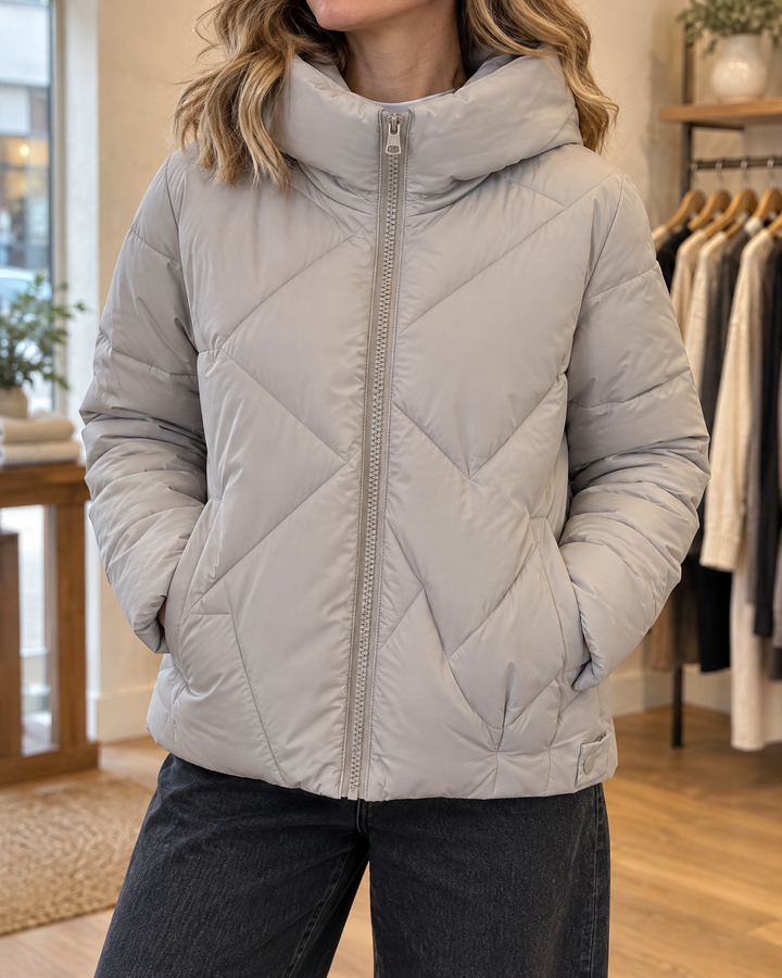 Bernadette - Hooded Padded Jacket in grey, detail of the zigzag quilting and the high hood collar