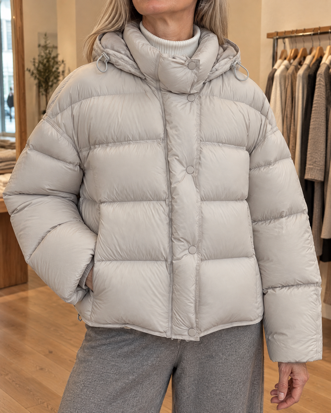 Annabelle - Hooded Down Puffer in cream, detail of the hood, the press-stud placket and the down baffles