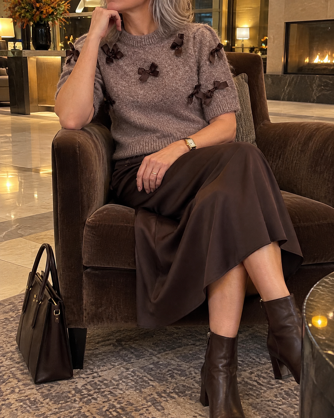 Juliette - Bow Sweater Top in brown, in a hotel lobby
