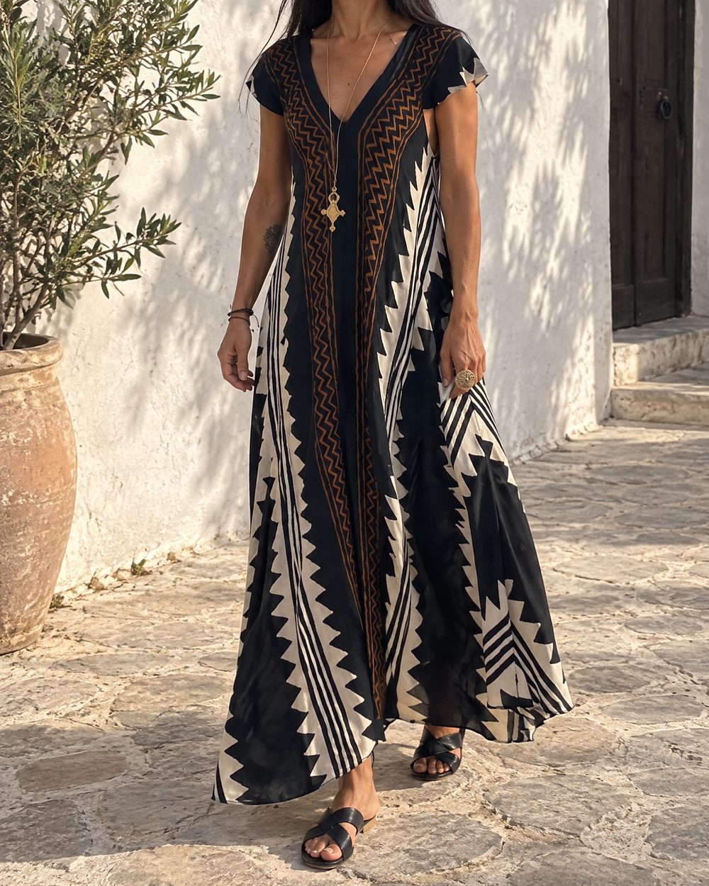 Ines - Colour Block Print Maxi Dress in black, in a courtyard