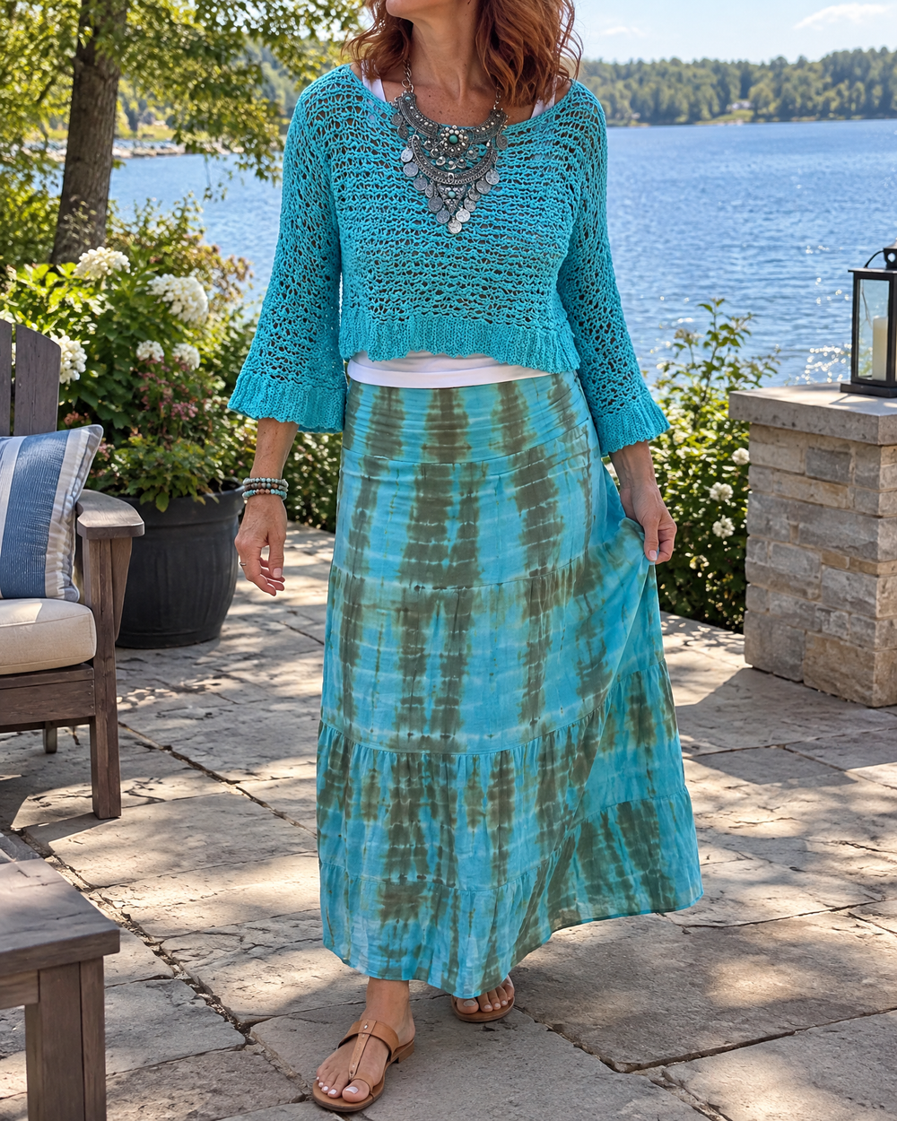 Zelie - Crochet Crop Sweater in turquoise, on a lakeside patio