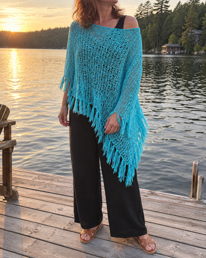 Oceane - Open Knit Tassel Poncho in turquoise, on the dock