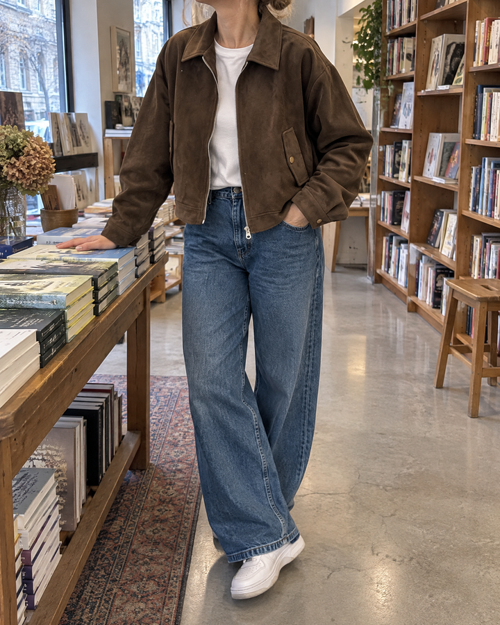 Rose - Cropped Faux Suede Jacket in chocolate brown, in a bookshop on a grey afternoon