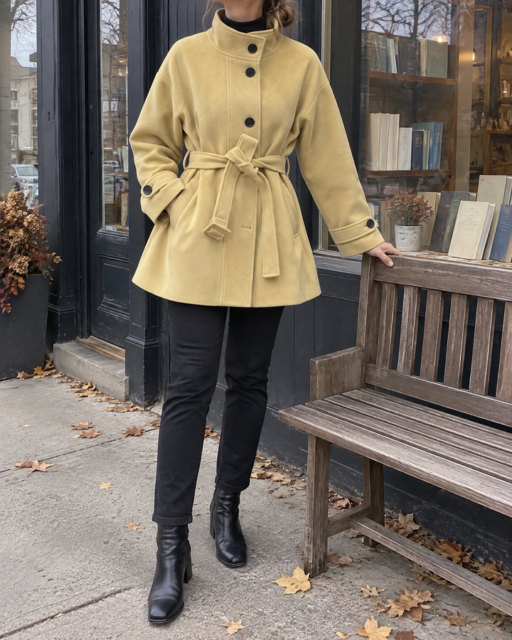 Lorelei - Belted Wool-Look Coat in mustard, outside a bookshop on an autumn morning