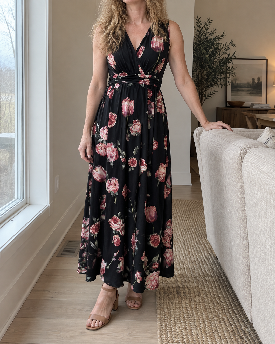Amelie - V-Neck Floral Maxi Dress in black, by a living-room window