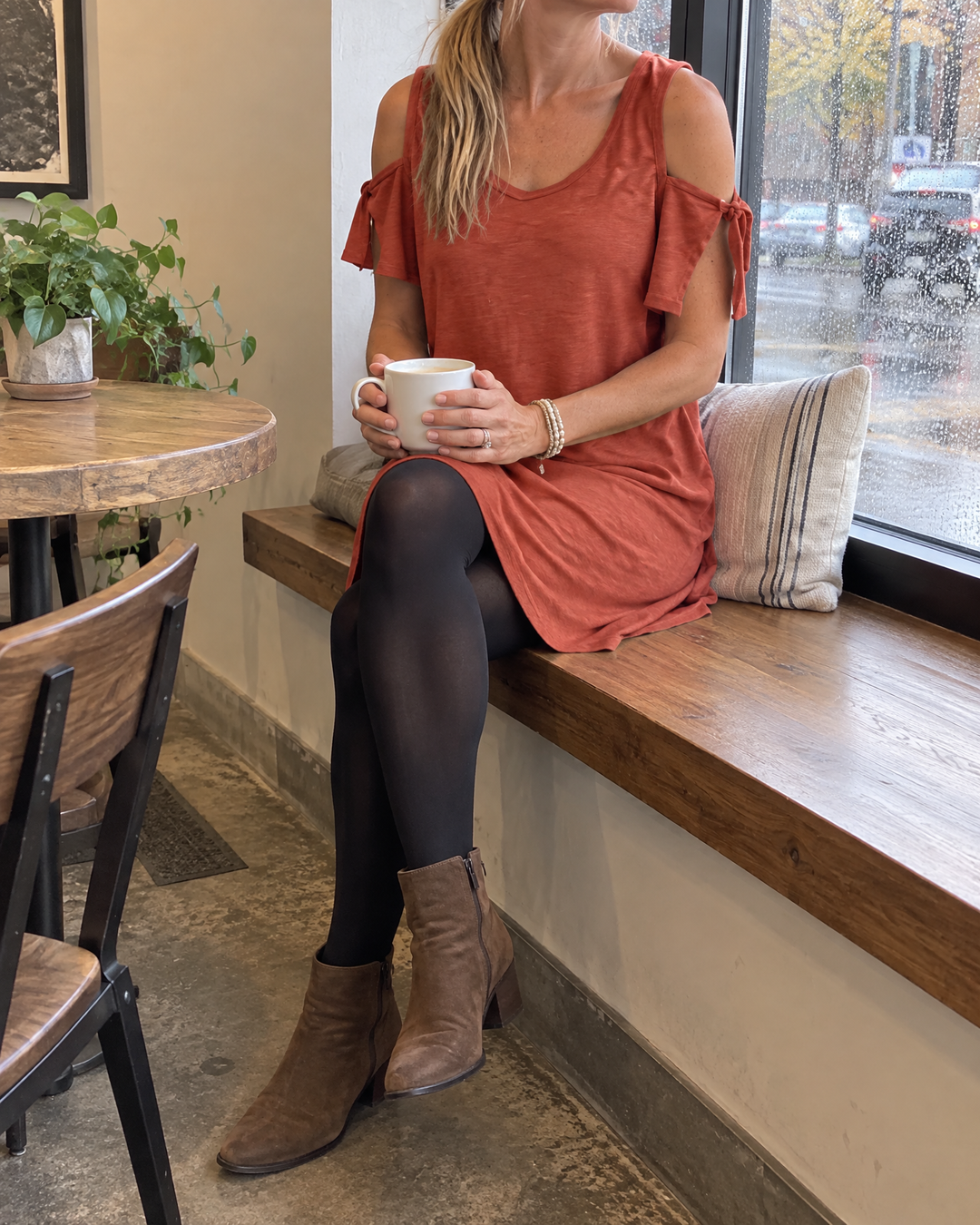 Yvette - Cold Shoulder Tee Dress in brick red, at a coffee shop window