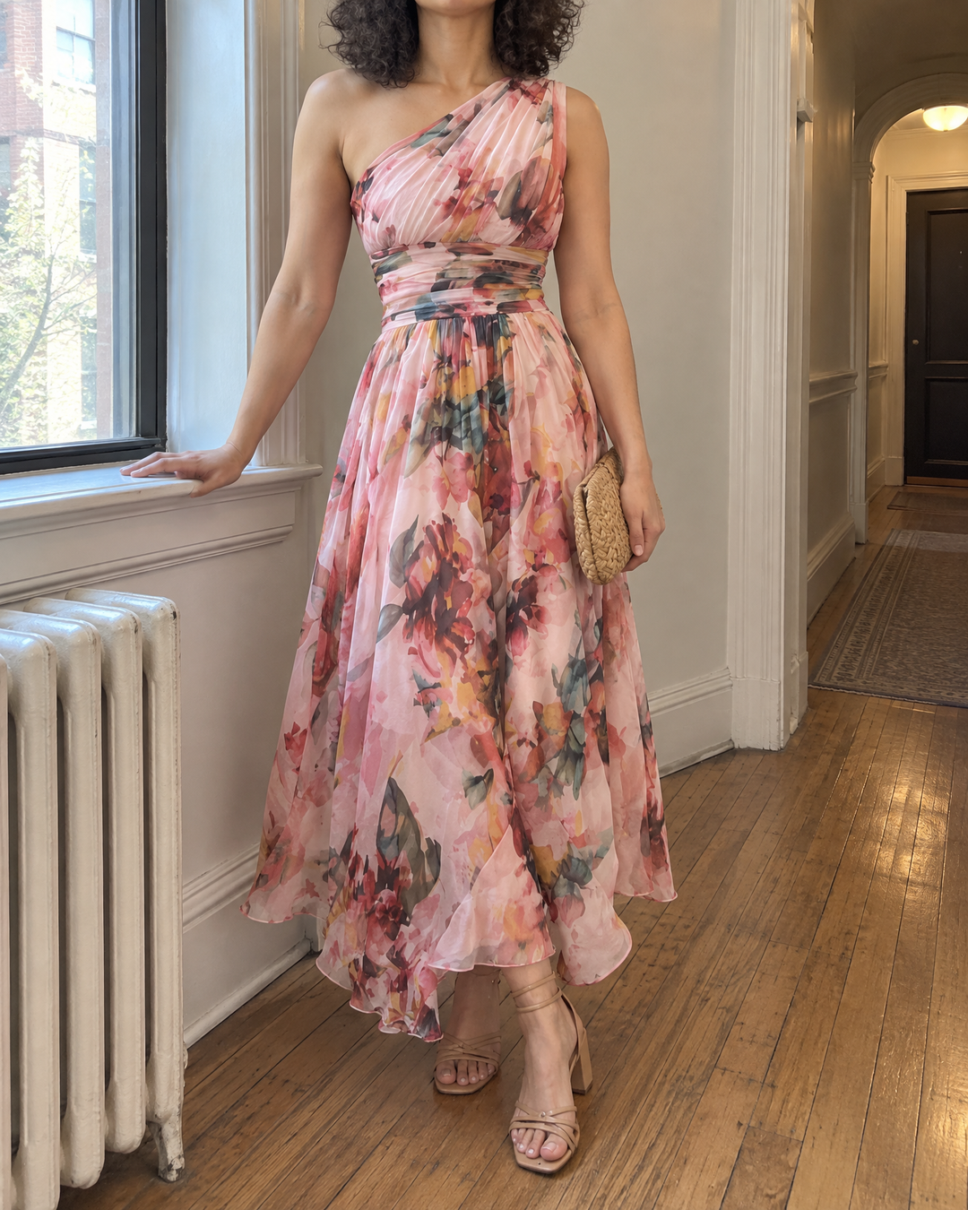 Giselle - One-Shoulder Floral Maxi Dress in pink, in a bright hallway