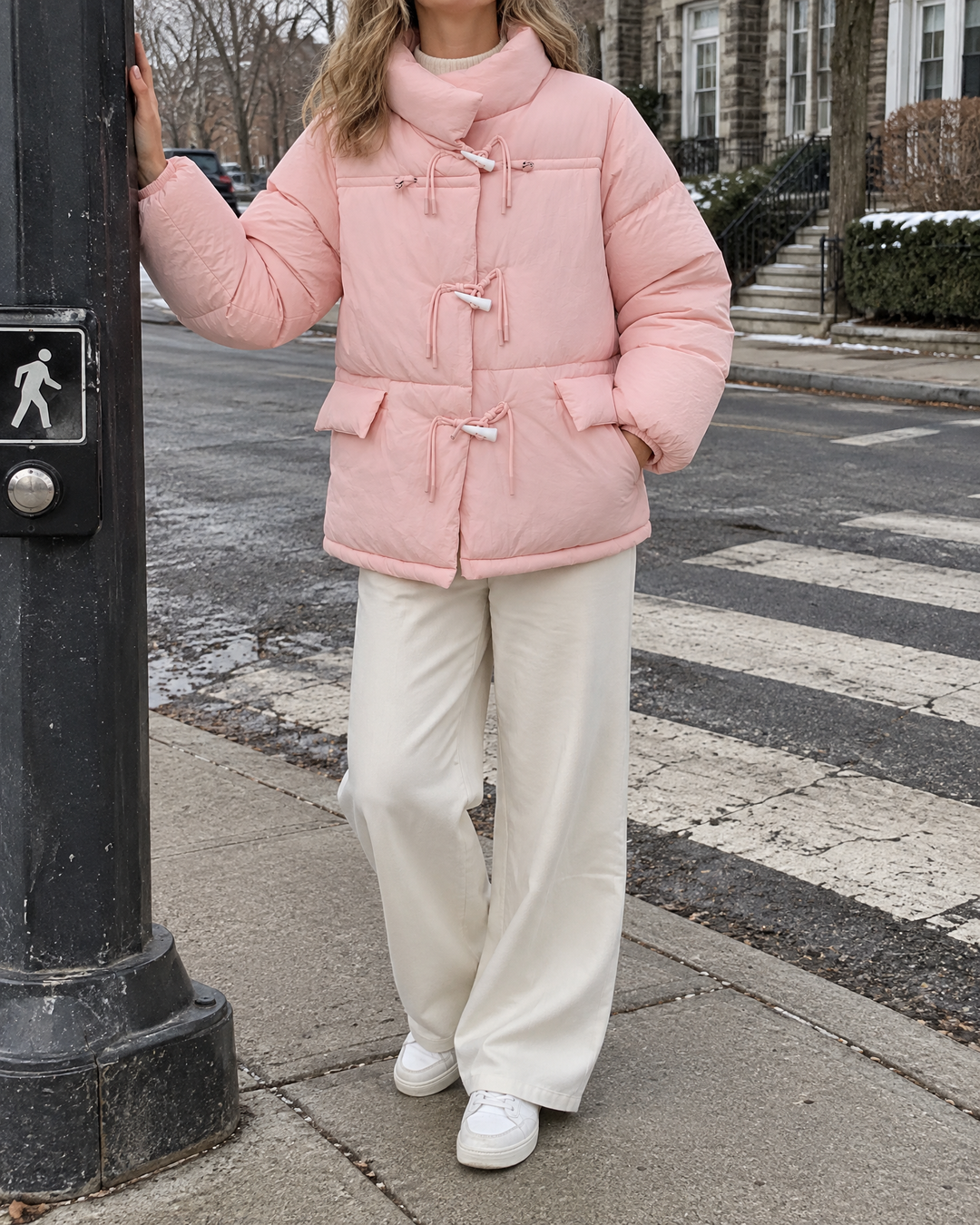 Ombeline - Toggle Button Puffer Jacket in pink, at a quiet street crossing on a cold morning