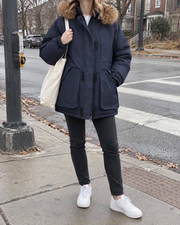 Francine - Oversized Hooded Parka in navy, crossing a quiet street on a cold morning