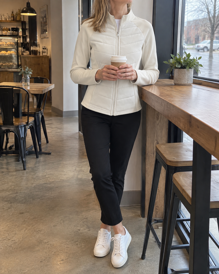 Ambre - Quilted Stand Collar Jacket in cream, with a coffee by the window