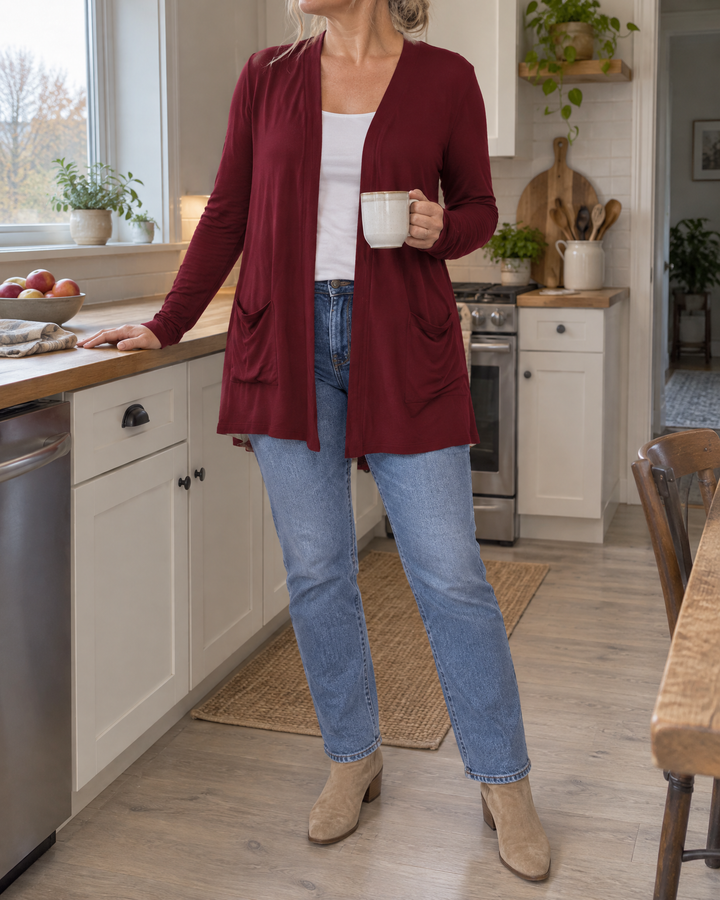 Nicolette - Longline Pocket Cardigan in wine, in the kitchen on a grey morning