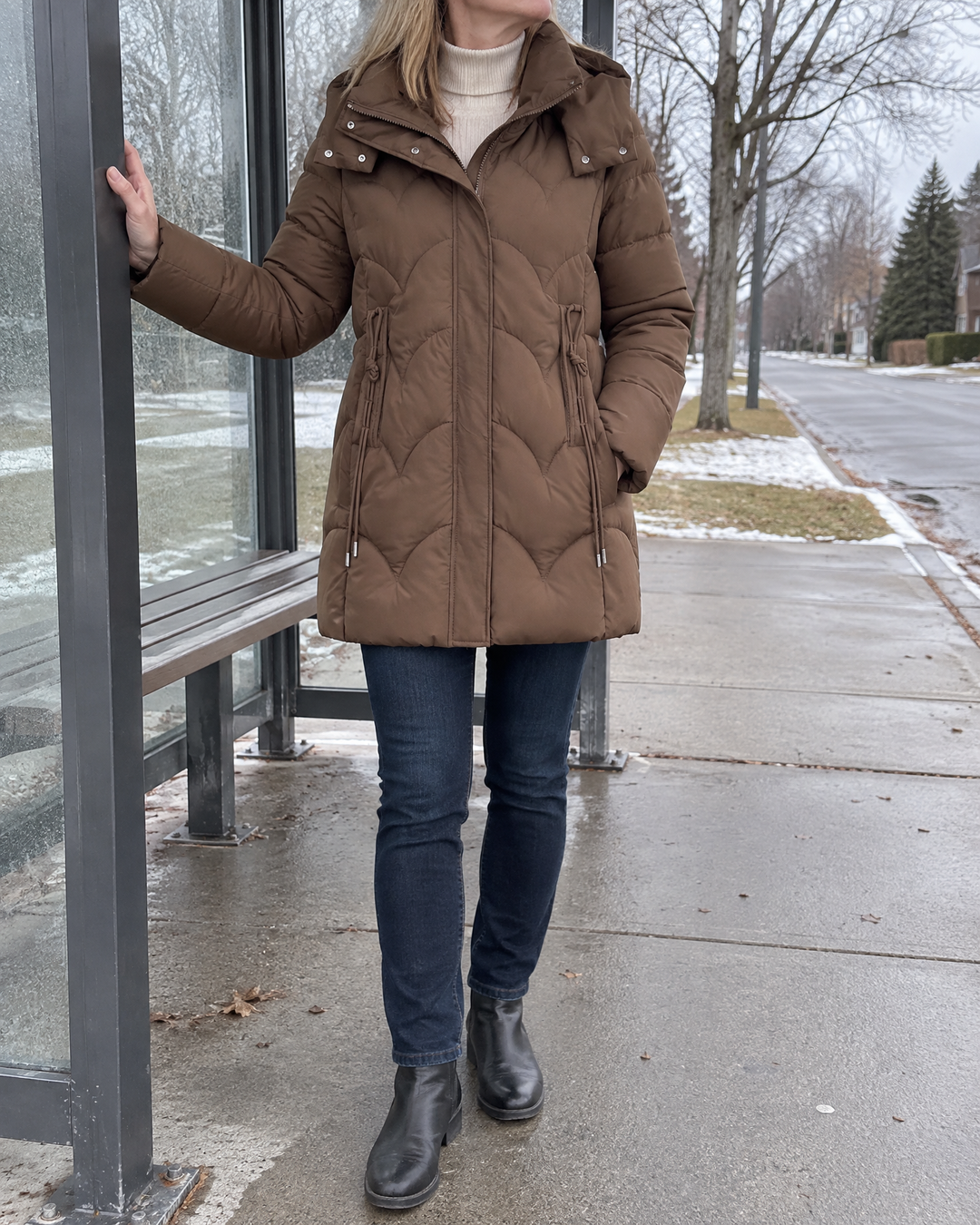 Esther - Wave Quilted Puffer Coat in mocha, waiting for the bus on a cold morning