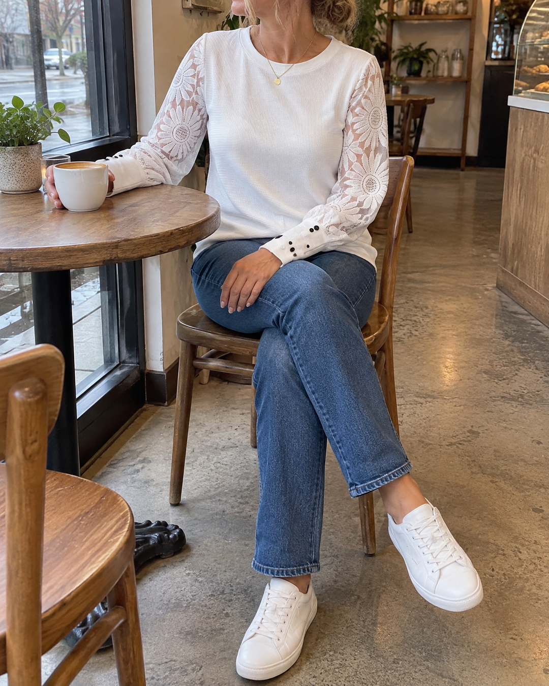 Laurine - Lace Sleeve Waffle Top in white, at a café table by the window