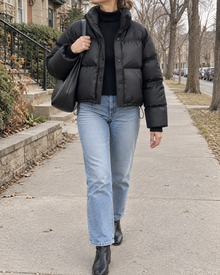 Anais - Cropped Faux Leather Puffer in black, on a quiet street in the fall