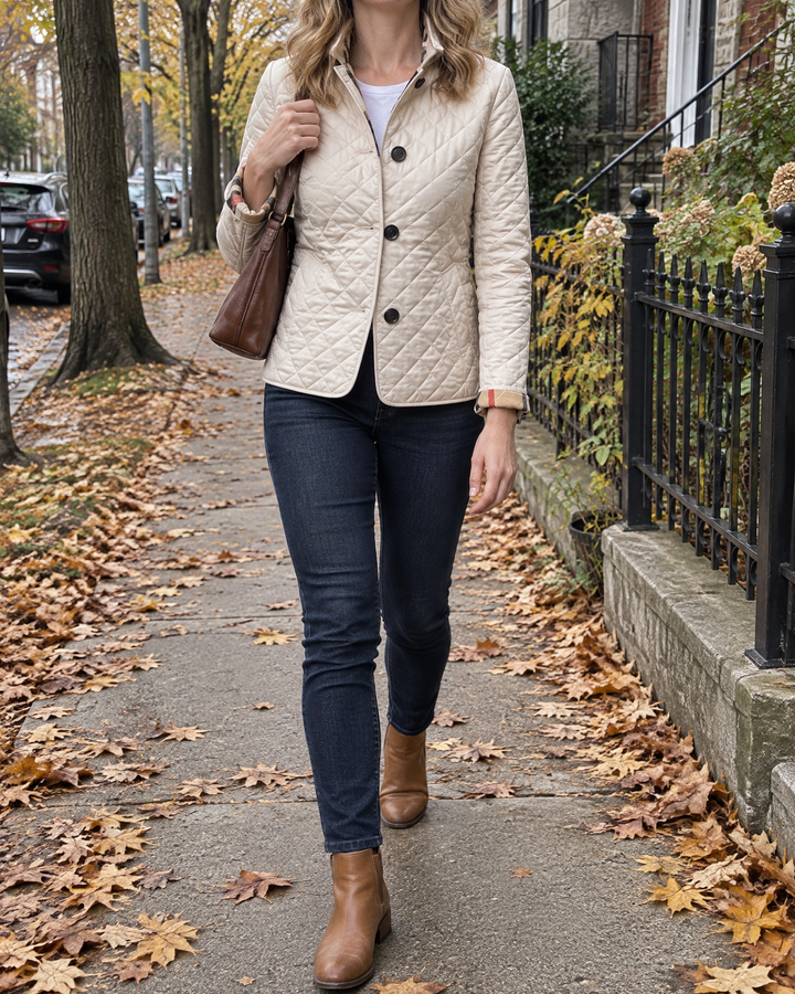 Claudine - Diamond Quilted Jacket in cream, on a quiet street on an autumn morning