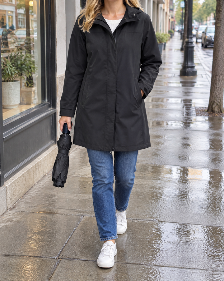 Jacqueline - Water-Repellent Hooded Coat in black, a city sidewalk after a shower