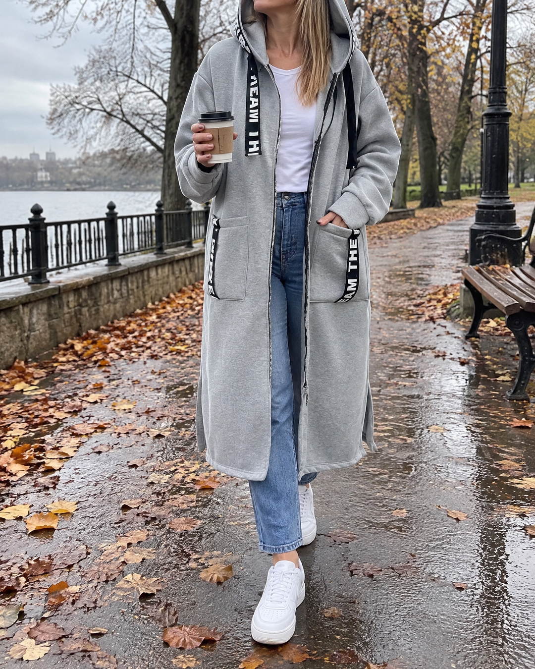 Adrienne - Hooded Fleece Coat in grey, on a park path after rain