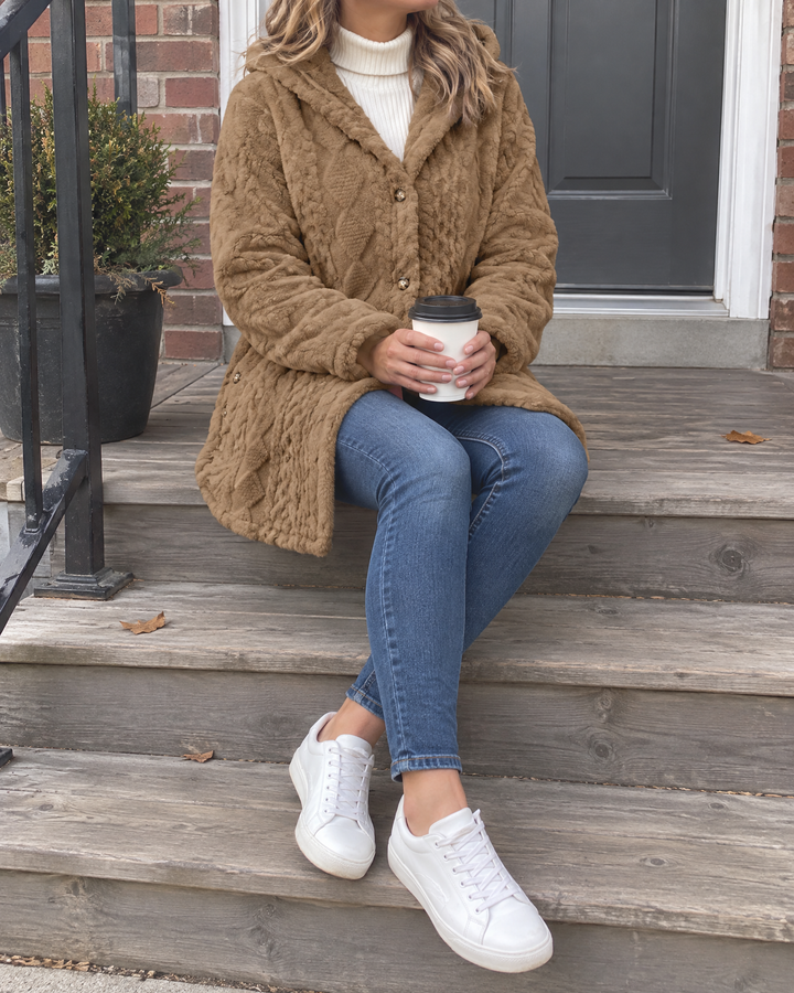 Corinne - Hooded Sherpa Jacket in camel, on the porch with a coffee