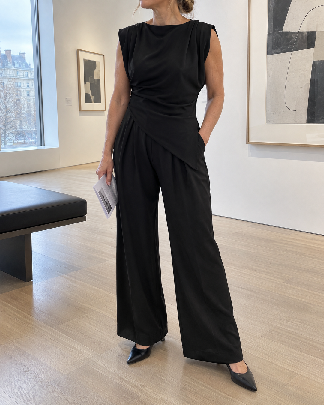 Jeanne - Asymmetric Sleeveless Set in black, at the gallery on a quiet afternoon